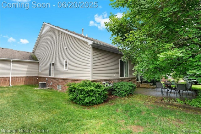 332 Asbury Ct, Highland, MI 48357 - view of side of home featuring brick siding, a yard, and a patio area