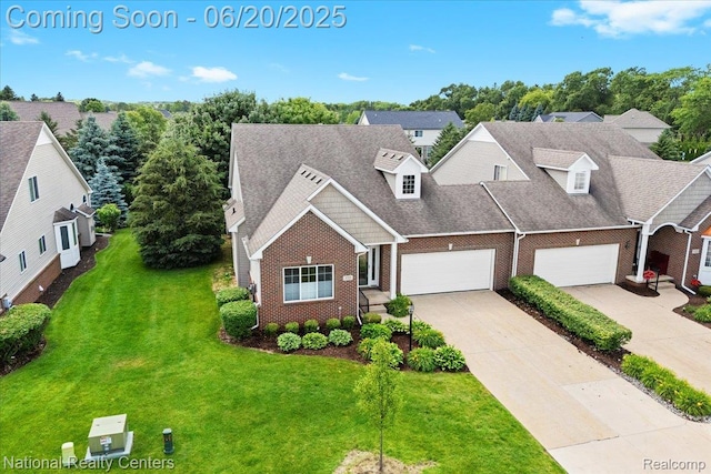 332 Asbury Ct, Highland, MI 48357 - view of front of home featuring brick siding, concrete driveway, a front yard, and an attached garage