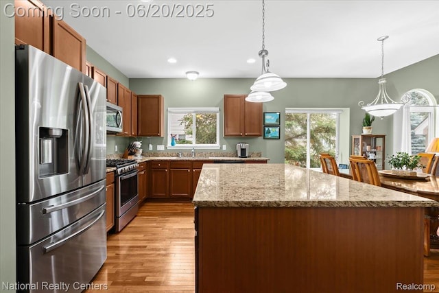 332 Asbury Ct, Highland, MI 48357 - kitchen featuring appliances with stainless steel finishes, a center island, light wood-style floors, pendant lighting, and recessed lighting