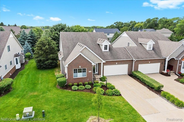 332 Asbury Ct, Highland, MI 48357 - view of front of house with brick siding, concrete driveway, a front yard, and a garage