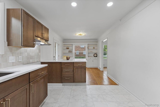 3900 Somerset Ave, Grosse Pointe Woods, MI 48224 - kitchen with under cabinet range hood, light marble finish floors, light countertops, backsplash, and recessed lighting