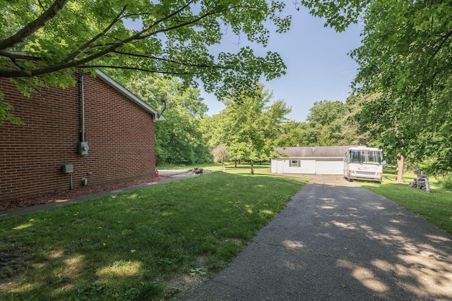 10229 N 22nd St, Plainwell, MI 49080 - view of green lawn with asphalt driveway