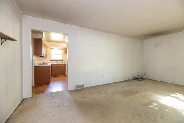 10229 N 22nd St, Plainwell, MI 49080 - carpeted empty room with baseboards and a sink
