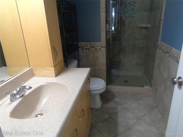 225 Brookwood Dr Unit 10, South Lyon, MI 48178 - bathroom with tile walls, a shower stall, vanity, tile patterned floors, and wainscoting