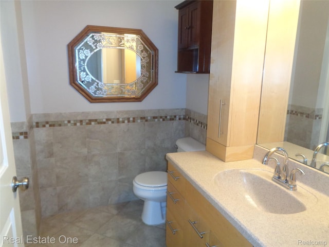 225 Brookwood Dr Unit 10, South Lyon, MI 48178 - bathroom with tile walls, tile patterned floors, vanity, and a wainscoted wall