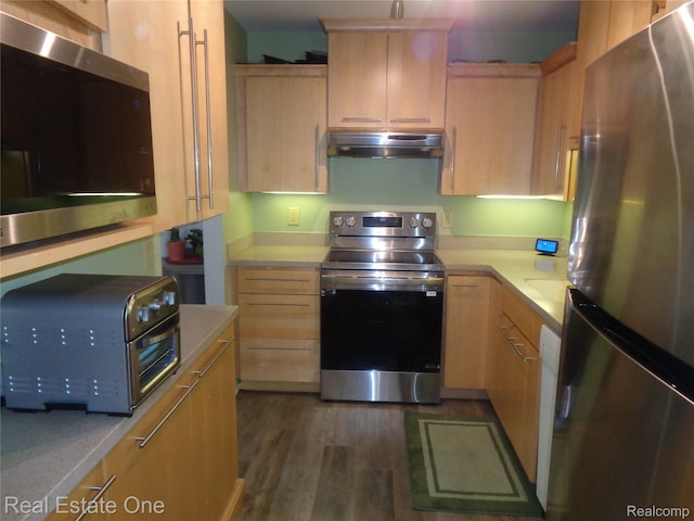 225 Brookwood Dr Unit 10, South Lyon, MI 48178 - kitchen featuring appliances with stainless steel finishes, under cabinet range hood, light brown cabinetry, light countertops, and dark wood finished floors
