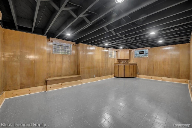 5500 Harvard Rd, Detroit, MI 48224 - below grade area with tile patterned floors, healthy amount of natural light, and wood walls