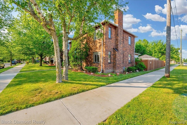 5500 Harvard Rd, Detroit, MI 48224 - view of side of home with a chimney and brick siding
