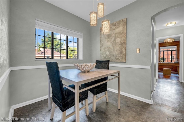 5500 Harvard Rd, Detroit, MI 48224 - dining room featuring plenty of natural light, a chandelier, and arched walkways