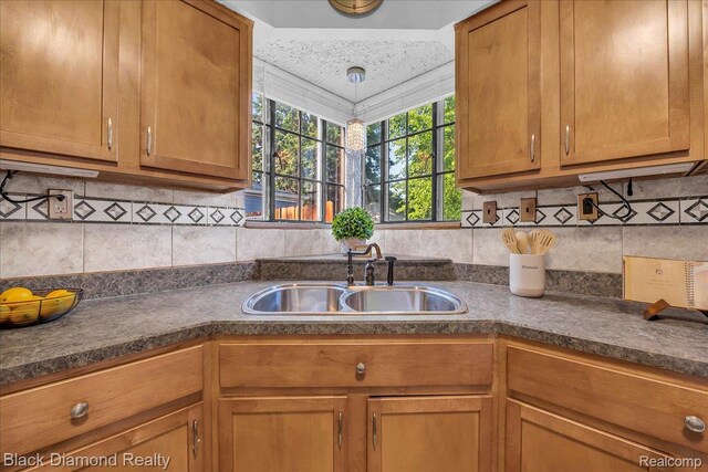 5500 Harvard Rd, Detroit, MI 48224 - kitchen with dark countertops, brown cabinets, and backsplash