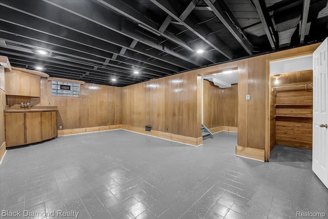 5500 Harvard Rd, Detroit, MI 48224 - basement with tile patterned floors, wood walls, and stairway