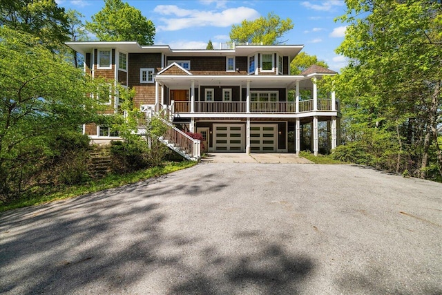 4679-4681 Forest Ridge Dr, Holland, MI 49423 - view of front facade with asphalt driveway, a garage, a porch, and stairs