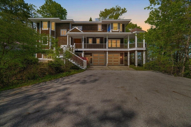 4679-4681 Forest Ridge Dr, Holland, MI 49423 - view of front facade with driveway, an attached garage, stairway, and a porch