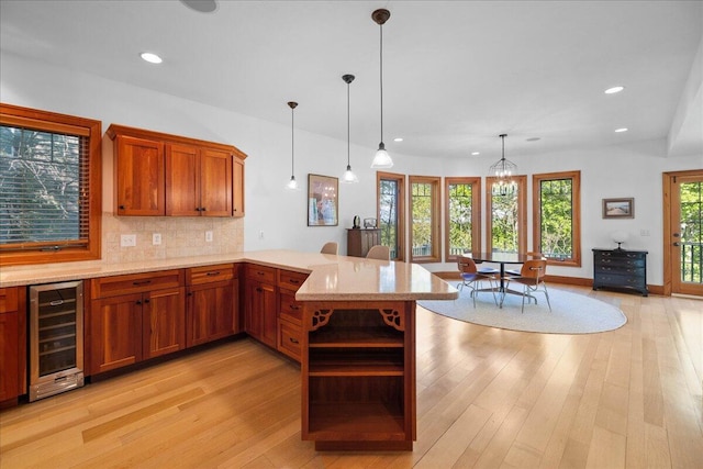 4679-4681 Forest Ridge Dr, Holland, MI 49423 - kitchen with wine cooler, open shelves, a peninsula, recessed lighting, and light stone countertops