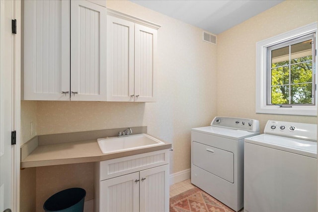 4679-4681 Forest Ridge Dr, Holland, MI 49423 - washroom featuring cabinet space, washer and dryer, and light tile patterned flooring
