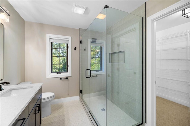 4679-4681 Forest Ridge Dr, Holland, MI 49423 - bathroom featuring vanity, a stall shower, a walk in closet, and tile patterned flooring