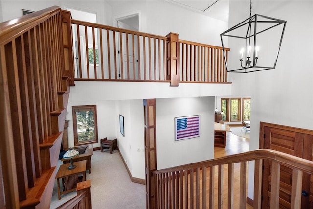 4679-4681 Forest Ridge Dr, Holland, MI 49423 - stairway with a towering ceiling, carpet flooring, and a chandelier