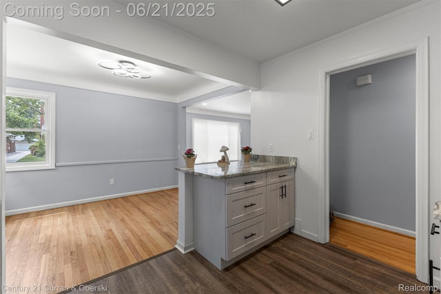 8276 Riverview St, Dearborn Heights, MI 48127 - kitchen with dark wood finished floors, light stone counters, and a peninsula