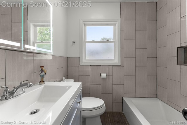 8276 Riverview St, Dearborn Heights, MI 48127 - bathroom with a tub to relax in, vanity, tile walls, and wainscoting