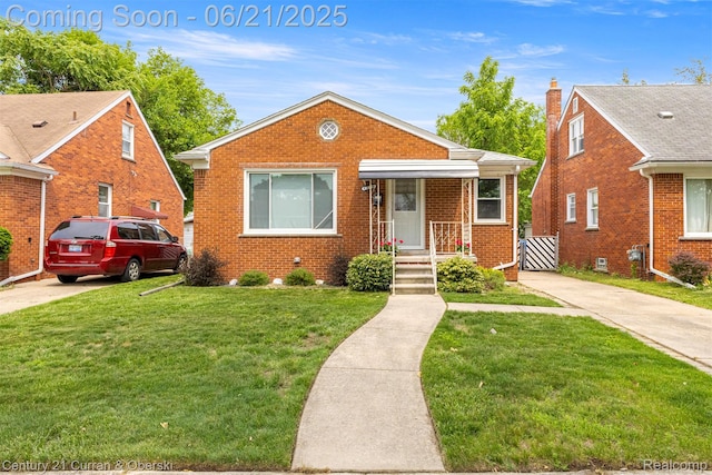 8276 Riverview St, Dearborn Heights, MI 48127 - bungalow-style house featuring brick siding, a front yard, and driveway