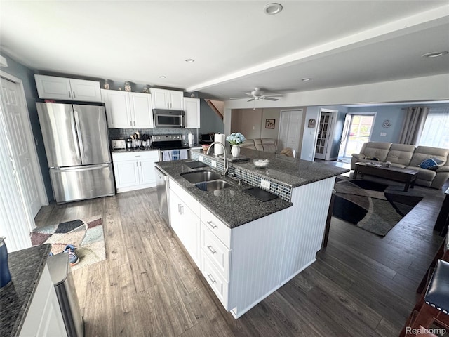 37805 Maplehill St, Harrison Township, MI 48045 - kitchen with appliances with stainless steel finishes, tasteful backsplash, a ceiling fan, dark wood-style flooring, and white cabinetry