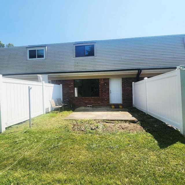 4536 Westbrook Dr Unit 46, Jackson, MI 49201 - back of property featuring a patio, brick siding, and a fenced backyard