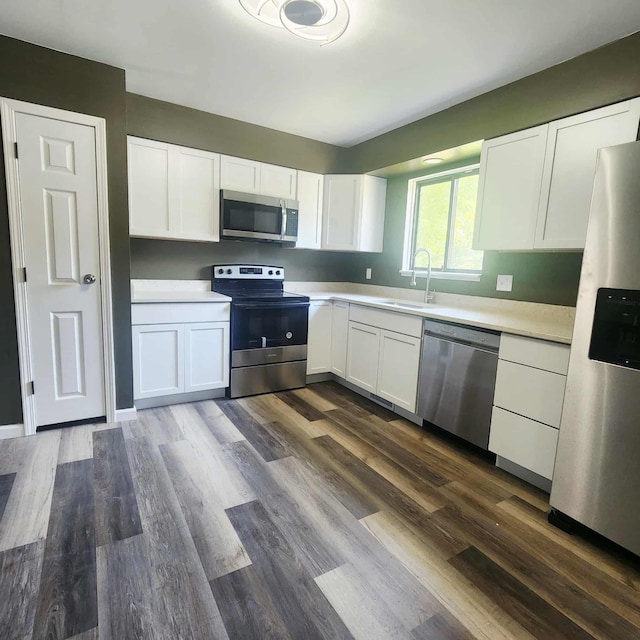 4536 Westbrook Dr Unit 46, Jackson, MI 49201 - kitchen featuring stainless steel appliances, white cabinetry, dark wood-style flooring, and light countertops
