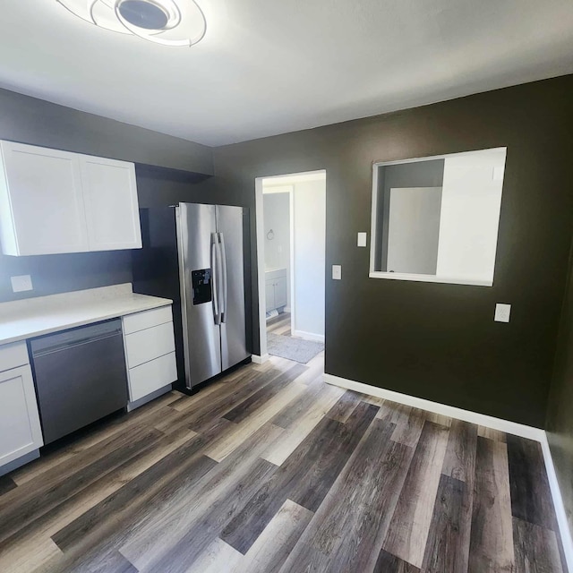 4536 Westbrook Dr Unit 46, Jackson, MI 49201 - kitchen featuring appliances with stainless steel finishes, light countertops, white cabinetry, and dark wood-style floors