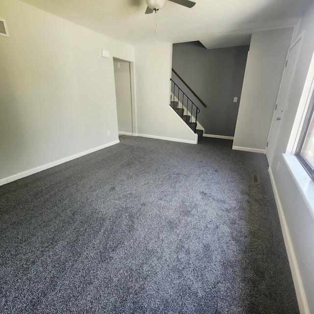 4536 Westbrook Dr Unit 46, Jackson, MI 49201 - unfurnished living room with a ceiling fan, stairs, and dark colored carpet