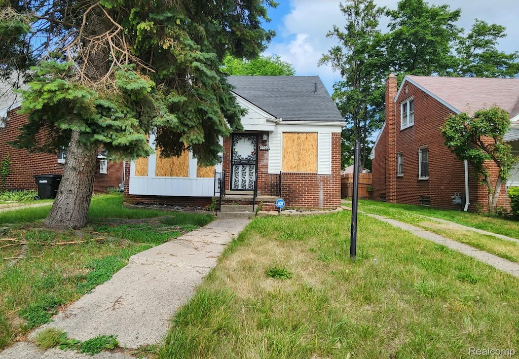 20290 Greydale Ave, Detroit, MI 48219 - bungalow with a front lawn, brick siding, and a shingled roof