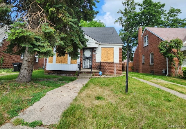 20290 Greydale Ave, Detroit, MI 48219 - bungalow with a front lawn, brick siding, and a shingled roof