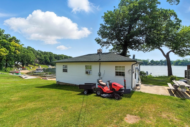 17295 Stevens Forest Lake St, Cassopolis, MI 49031 - rear view of house with a patio, a yard, a water view, a chimney, and cooling unit