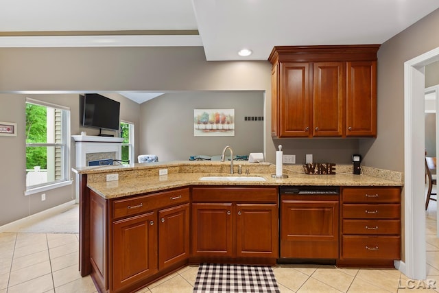3054 Windmill Dr, Adrian, MI 49221 - kitchen with a peninsula, light stone counters, a fireplace, light tile patterned floors, and recessed lighting