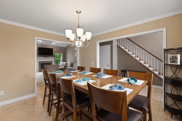 3054 Windmill Dr, Adrian, MI 49221 - dining area with light tile patterned floors, stairway, crown molding, a chandelier, and a fireplace