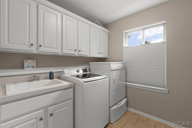 3054 Windmill Dr, Adrian, MI 49221 - washroom featuring washer and dryer, cabinet space, and light tile patterned floors