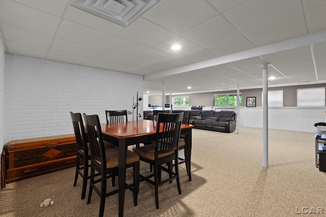 3054 Windmill Dr, Adrian, MI 49221 - dining area with brick wall, a paneled ceiling, and carpet