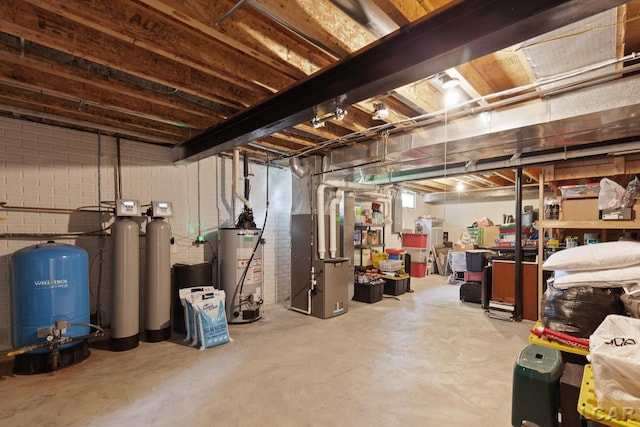 3054 Windmill Dr, Adrian, MI 49221 - unfinished below grade area featuring a water pressure tank, gas water heater, heating unit, and a water softener system