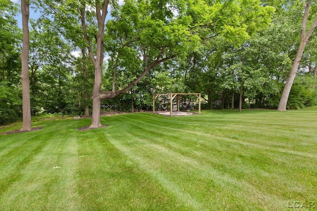 3054 Windmill Dr, Adrian, MI 49221 - view of grassy yard with a pergola