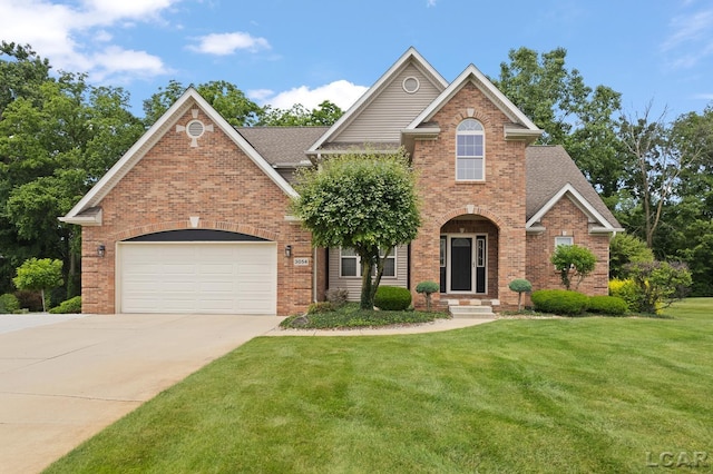 3054 Windmill Dr, Adrian, MI 49221 - traditional home with brick siding, driveway, a front lawn, and a garage