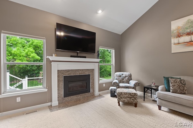 3054 Windmill Dr, Adrian, MI 49221 - carpeted living area with healthy amount of natural light, vaulted ceiling, and a high end fireplace