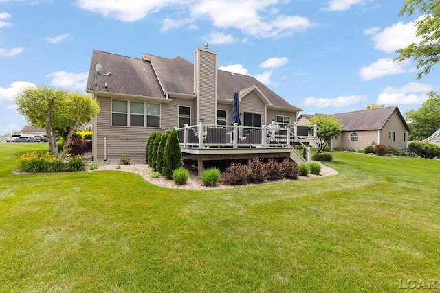 3054 Windmill Dr, Adrian, MI 49221 - back of house featuring a wooden deck, a chimney, and a yard