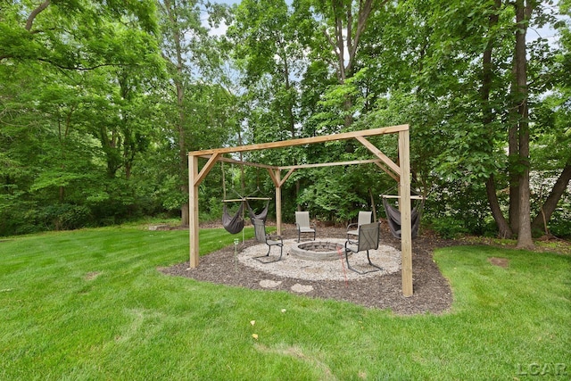 3054 Windmill Dr, Adrian, MI 49221 - view of green lawn with an outdoor fire pit and a patio area