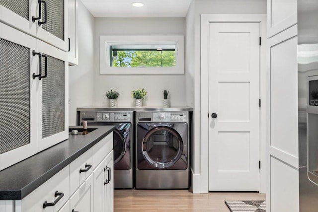 16128 Walnut Ct, Three Oaks, MI 49128 - washroom featuring separate washer and dryer, light wood-type flooring, recessed lighting, and cabinet space