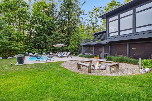 16128 Walnut Ct, Three Oaks, MI 49128 - view of green lawn featuring a patio area, an outdoor pool, and an outdoor fire pit