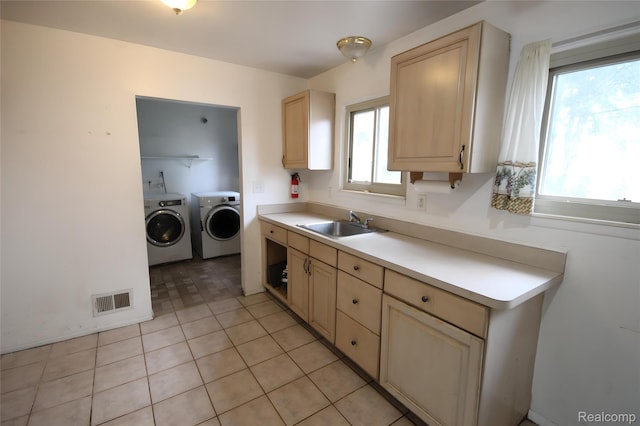 21325 Marie Ave, Warren, MI 48089 - kitchen with separate washer and dryer, light countertops, and light brown cabinetry