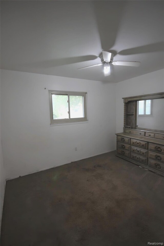 21325 Marie Ave, Warren, MI 48089 - unfurnished bedroom featuring dark carpet and a ceiling fan