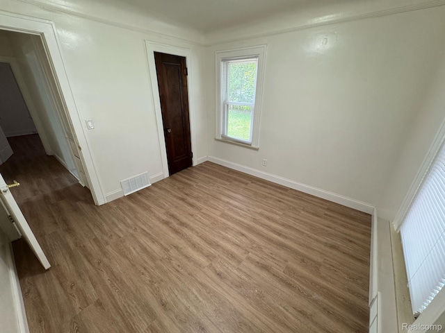 28905 Hennepin St, Dearborn Heights, MI 48135 - unfurnished bedroom with light wood-type flooring and crown molding