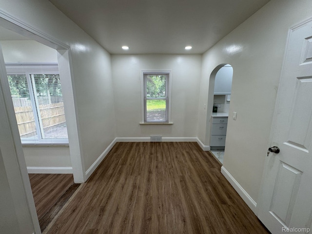 28905 Hennepin St, Dearborn Heights, MI 48135 - empty room featuring arched walkways, dark wood-style floors, healthy amount of natural light, and recessed lighting