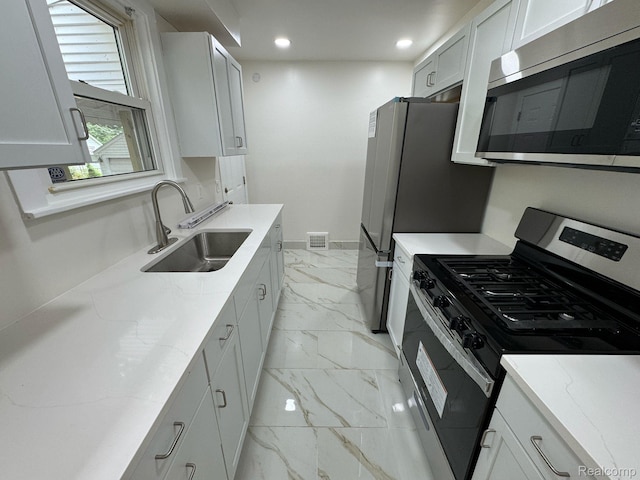 28905 Hennepin St, Dearborn Heights, MI 48135 - kitchen featuring appliances with stainless steel finishes, light marble finish floors, light stone countertops, and recessed lighting