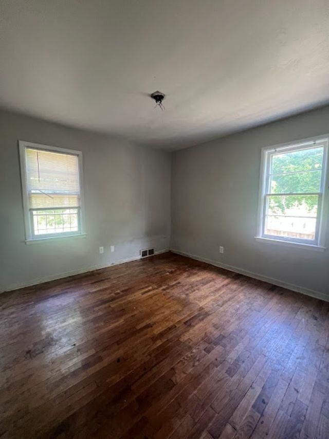 3501 Fleming Rd, Flint, MI 48504 - spare room featuring dark wood finished floors and healthy amount of natural light